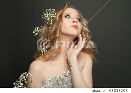 Nice woman with healthy curly hairdo and spring 63058208