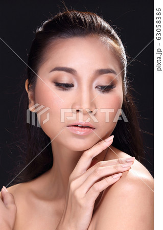 Beautiful young Asian woman with clean fresh skin Beautiful young Asian woman with clean fresh skin 63058386