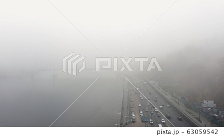A city covered in fog. City traffic, aerial view 63059542