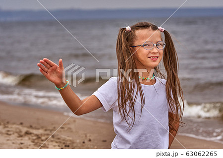 Portrait of a teenage girl in glasses and a white Portrait of a teenage girl in glasses and a white 63062265