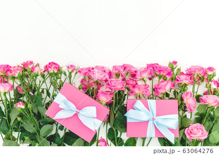 Floral frame of roses flowers and gifts on white background. Flat lay, Top view. Happy birthday Floral frame of roses flowers and gifts on white background. Flat lay, Top view. Happy birthday 63064276
