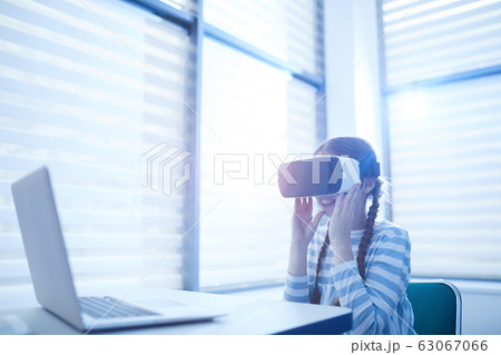 Curious Girl Using VR Glasses 63067066