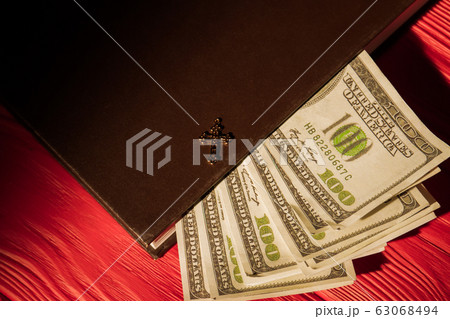 Money, holy bible and golden cross. Money, holy bible and golden cross. 63068494