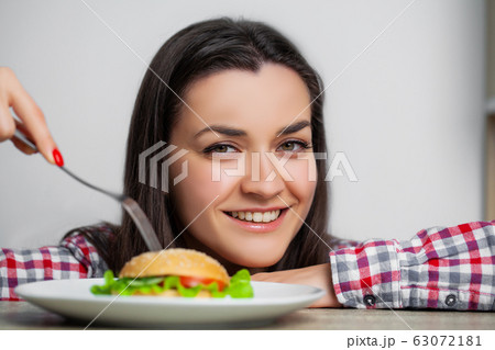 Nice girl wants to eat hamburger harmful Nice girl wants to eat hamburger harmful 63072181