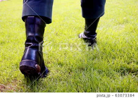 Body part a man walking.He walking on grass background.He wear black shoes.going,move on,fright,develop,Grow up. Body part a man walking.He walking on grass background.He wear black shoes.going,move on,fright,develop,Grow up. 63073384