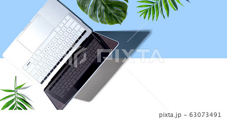 Laptop computer with tropical plants Laptop computer with tropical plants 63073491