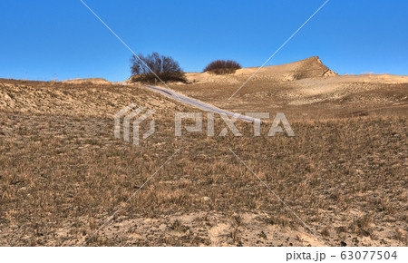 View of nordic sand dunes and pathways, Baltic sea at Curonian spit, Nida, Klaipeda, Lithuania View of nordic sand dunes and pathways, Baltic sea at Curonian spit, Nida, Klaipeda, Lithuania 63077504