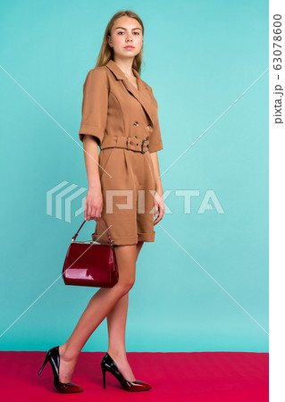 Young fashion woman hold handbag clutch isolated 63078600