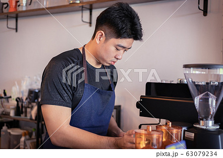 Attractive Asian barista the coffee shop owner Attractive Asian barista the coffee shop owner 63079234