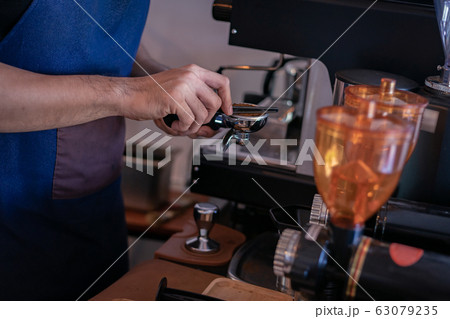 Attractive Asian barista the coffee shop owner Attractive Asian barista the coffee shop owner 63079235