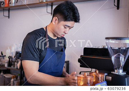 Attractive Asian barista the coffee shop owner Attractive Asian barista the coffee shop owner 63079236
