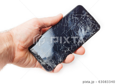 Hand holds a broken smartphone on a white Hand holds a broken smartphone on a white 63083340