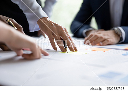 Close up of diverse businesspeople collaborating at meeting Close up of diverse businesspeople collaborating at meeting 63083743