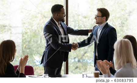 African American businessman handshake male colleague at meeting African American businessman handshake male colleague at meeting 63083795