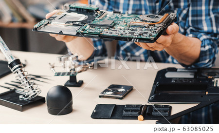 computer repair shop disassembled laptop device 63085025
