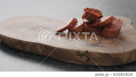 chorizo slices on olive wood board closeup chorizo slices on olive wood board closeup 63085828