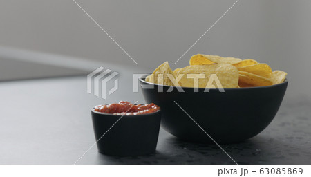 serve corn chips with salsa on concrete surface serve corn chips with salsa on concrete surface 63085869
