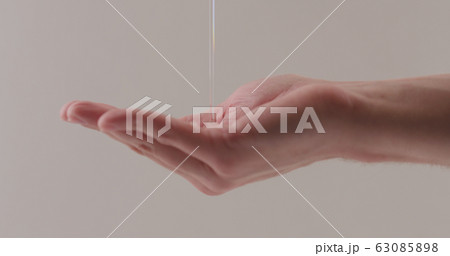 pour shower gel on man hand closeup 63085898
