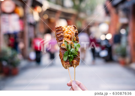 Young woman traveler walking holding stinky Tofu 63087636