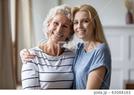 Portrait of happy mature mom and adult daughter hugging Portrait of happy mature mom and adult daughter hugging 63088163