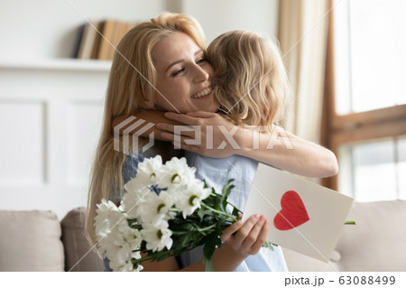 Little caring girl greeting mom with birthday Little caring girl greeting mom with birthday 63088499