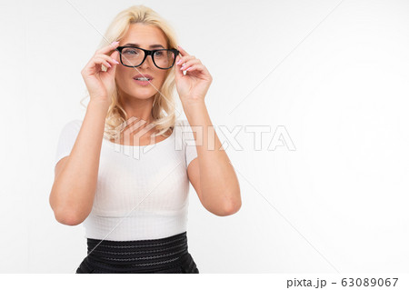 girl stares intently in glasses for vision on a white background with copy space girl stares intently in glasses for vision on a white background with copy space 63089067