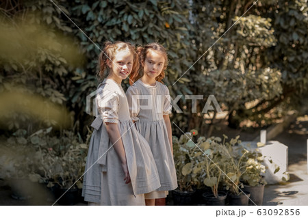 Two girls in school clothes have fun and play on the streets during the change 63092856