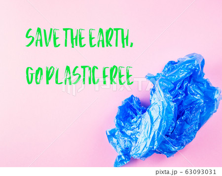 Crumpled blue plastic trash bag on pink background 63093031