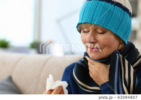 Sick lady touching sore throat 63094807