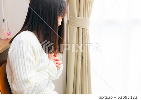 胸を抑える女性　胸の疾患　コピースペース 63095123