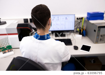 Male researcher in lab coat working in science laboratory Male researcher in lab coat working in science laboratory 63096795