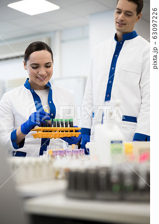 Smiling research scientists doing blood tests in science lab 63097226