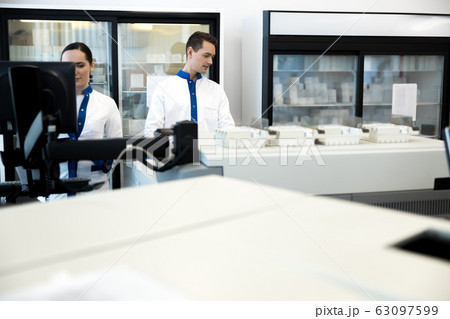 Two research scientists working in modern laboratory 63097599