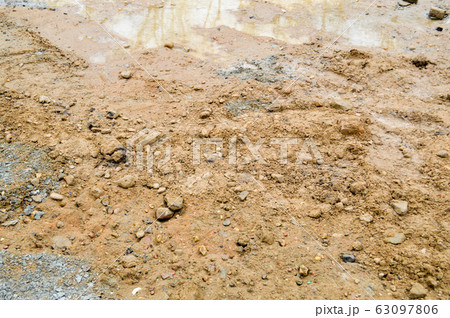 Texture of a dirty bad dirt road dirt road with  63097806