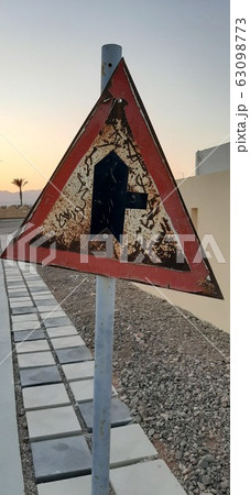 Old in poor condition road sign made of metal Old in poor condition road sign made of metal 63098773