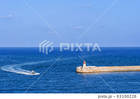 Sea Motorboat And Ricasoli Lighthouse Breakwater 63100226