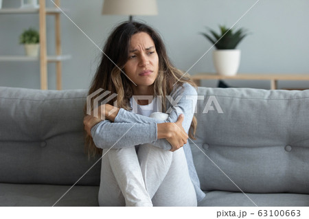 Sad millennial girl look in distance feel lonely or depressed 63100663