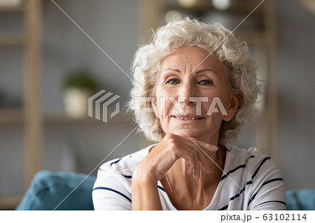 Portrait of optimistic elderly woman relaxing at home Portrait of optimistic elderly woman relaxing at home 63102114