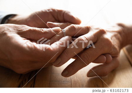 Elderly couple exchange wedding rings get engaged 63102173
