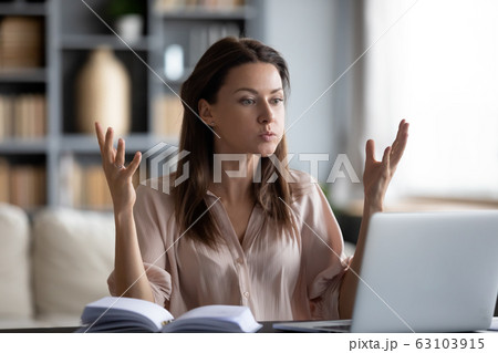 Unhappy young woman irritated by gadget work, low internet connection. 63103915
