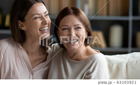 Smiling two female generation family dreaming of future together. Smiling two female generation family dreaming of future together. 63103921