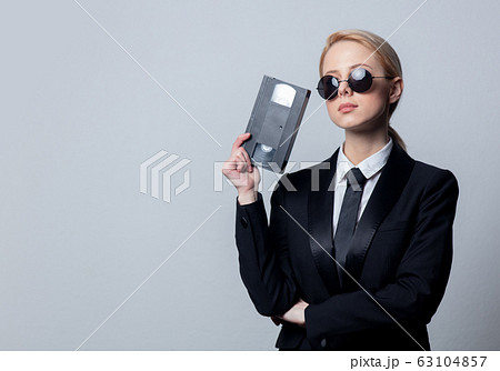 businesswoman in sunglasses with video tape 63104857