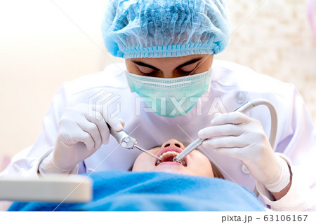 Dentist with tooth implant false teeth. Dentistry 63106167