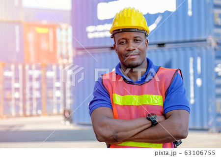 Technician man or worker in cargo container factory stand and action of confident 63106755