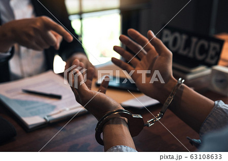 Police officers pointed to the handcuffs of Police officers pointed to the handcuffs of 63108633
