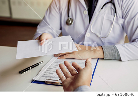 Asian male doctor talking in clinic room and 63108646