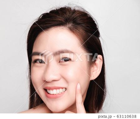 young beautiful asian woman with clean and bright skin, Cosmetic Beauty Concept,smiling face young beautiful asian woman with clean and bright skin, Cosmetic Beauty Concept,smiling face 63110638