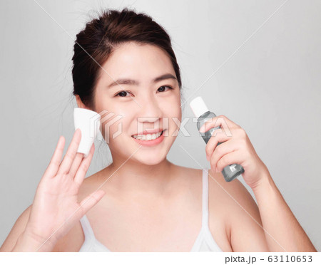 young beautiful asian woman with clean and bright skin, Cosmetic Beauty Concept,smiling face 63110653