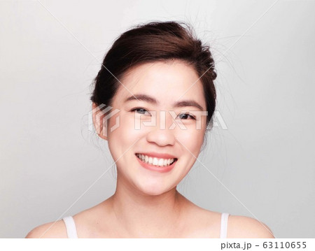young beautiful asian woman with clean and bright skin, Cosmetic Beauty Concept,smiling face 63110655