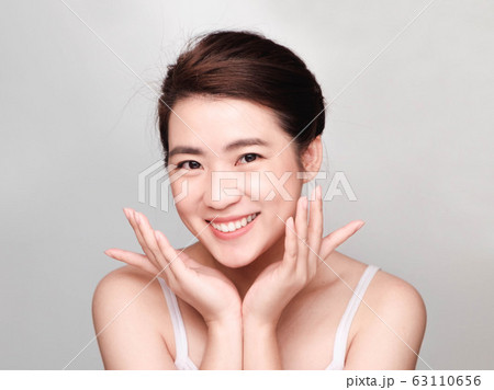 young beautiful asian woman with clean and bright skin, Cosmetic Beauty Concept,smiling face 63110656